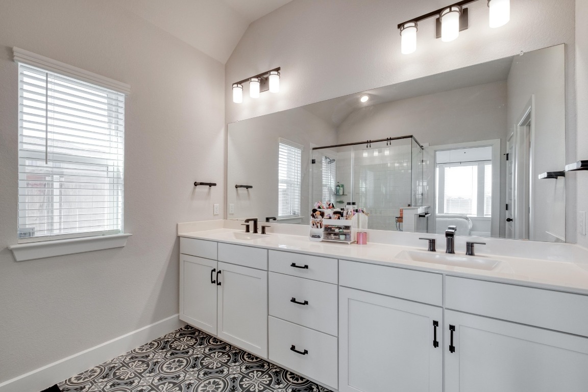 1113 Dog Iron Street Georgetown, TX 78633 - Photo 18 of 33 a bathroom with a double vanity sink and mirror with window