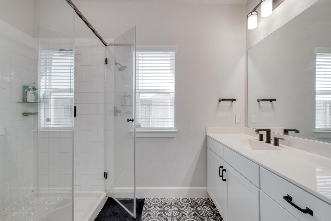 1113 Dog Iron Street Georgetown, TX 78633 - Photo 19 of 33 a bathroom with a sink and a mirror