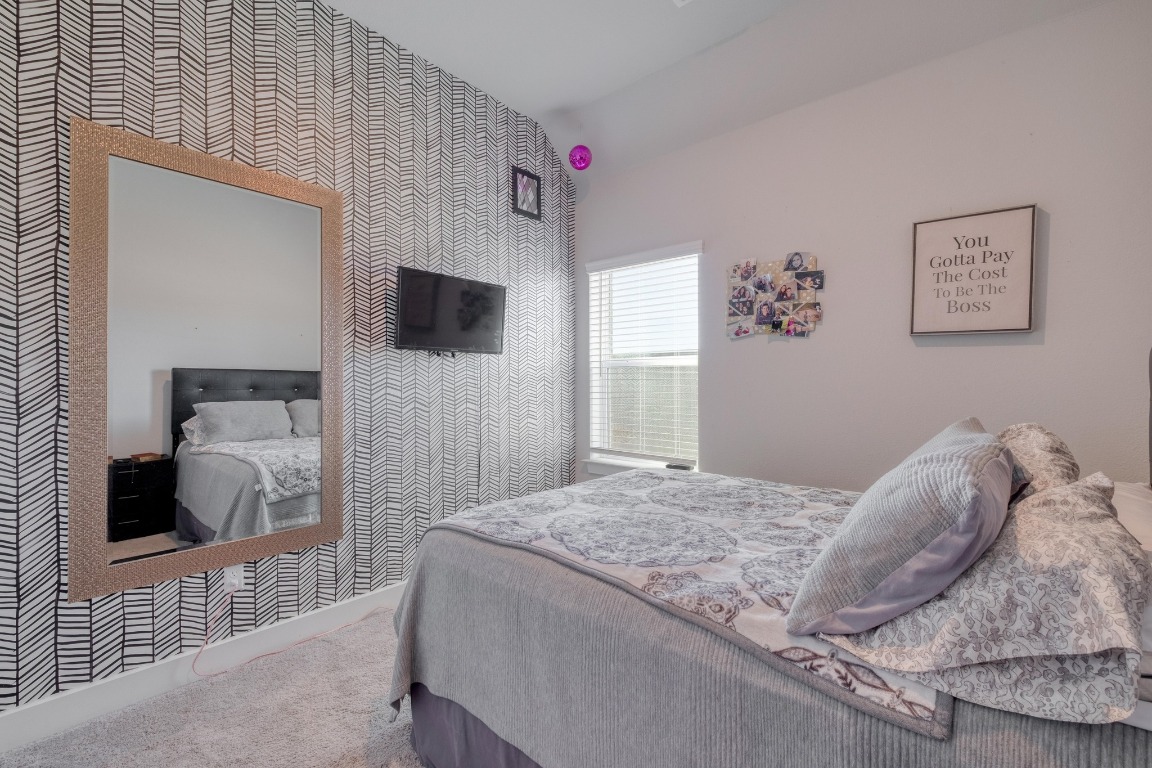 1113 Dog Iron Street Georgetown, TX 78633 - Photo 21 of 33 a bedroom with a bed and a flat screen tv