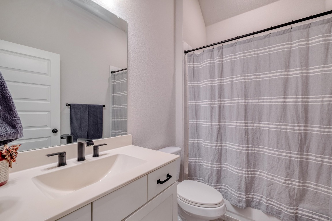 1113 Dog Iron Street Georgetown, TX 78633 - Photo 22 of 33 a bathroom with a sink a toilet and shower