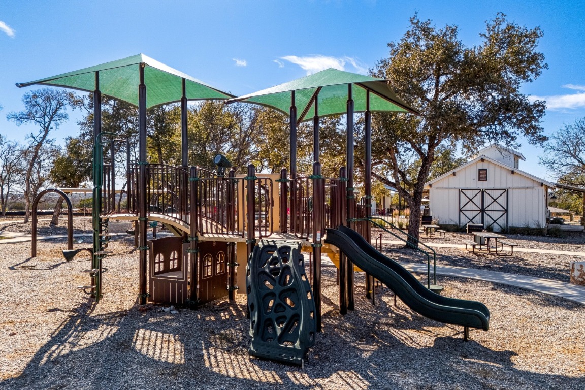 1113 Dog Iron Street Georgetown, TX 78633 - Photo 31 of 33 a view of a bench sitting under a large tree