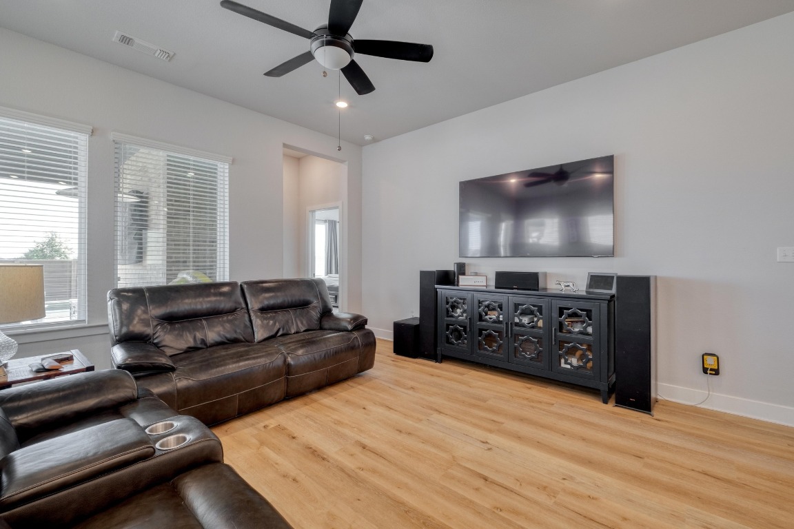 1113 Dog Iron Street Georgetown, TX 78633 - Photo 8 of 33 a living room with furniture and a flat screen tv
