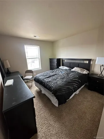 a bedroom with a bed and window