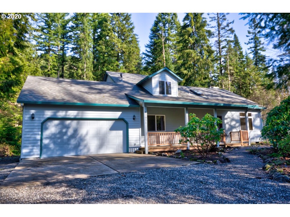 67051 East Barlow Trail Road Rhododendron, OR 97049 - Photo 1 of 32 a front view of a house with garden