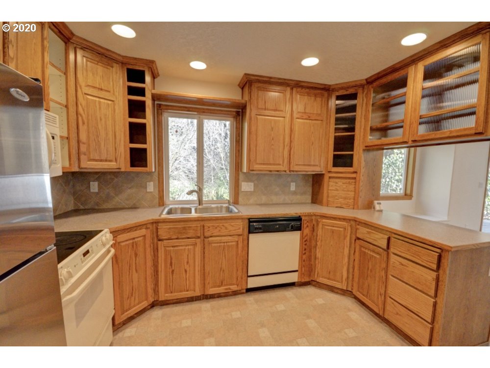 67051 East Barlow Trail Road Rhododendron, OR 97049 - Photo 11 of 32 a kitchen with stainless steel appliances granite countertop a sink and cabinets