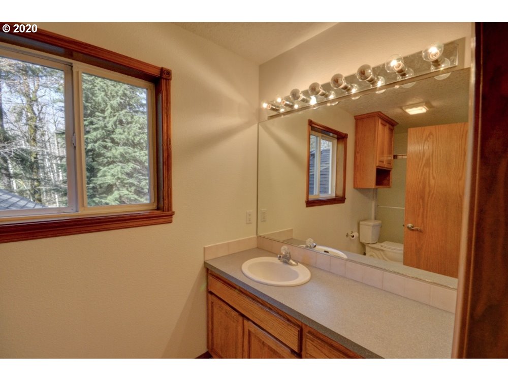 67051 East Barlow Trail Road Rhododendron, OR 97049 - Photo 15 of 32 a bathroom with a sink vanity and a mirror