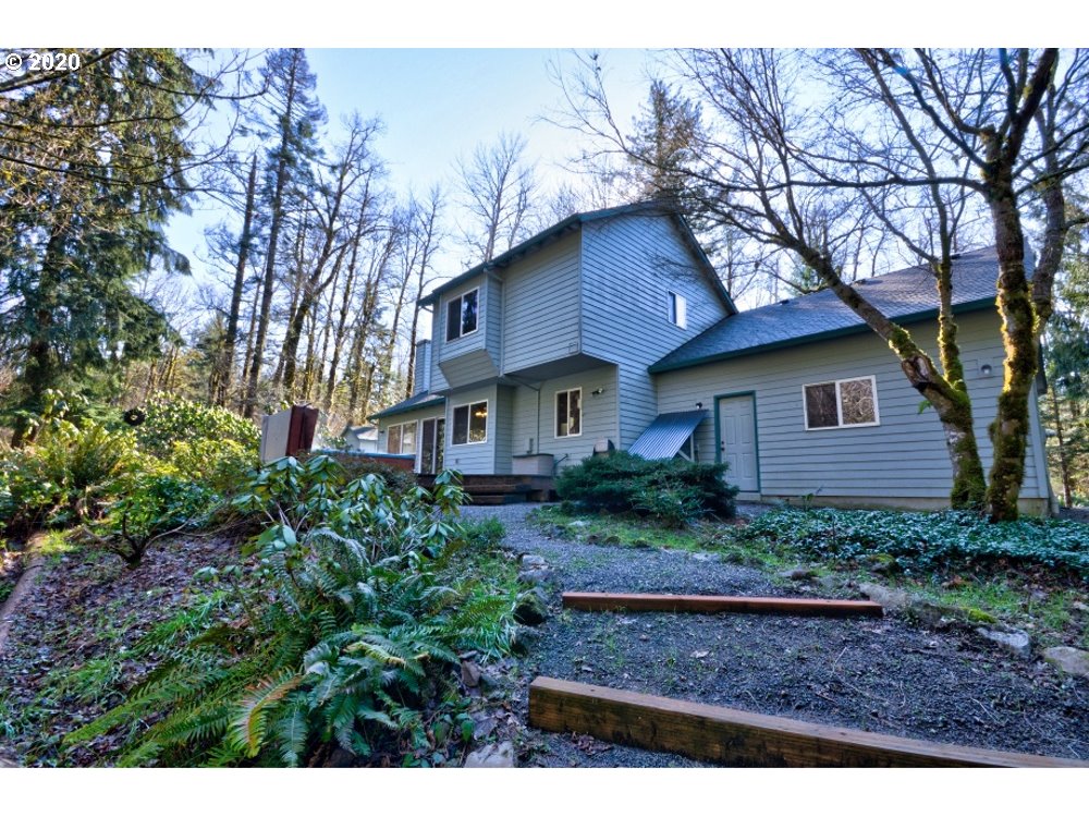67051 East Barlow Trail Road Rhododendron, OR 97049 - Photo 2 of 32 a view of a house with a yard