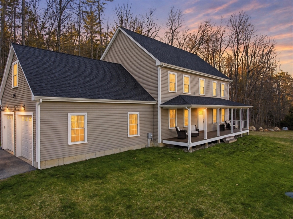 103 Rice Corner Road Brookfield, MA 01506 - Photo 3 of 39 a front view of a house with a yard table and chairs