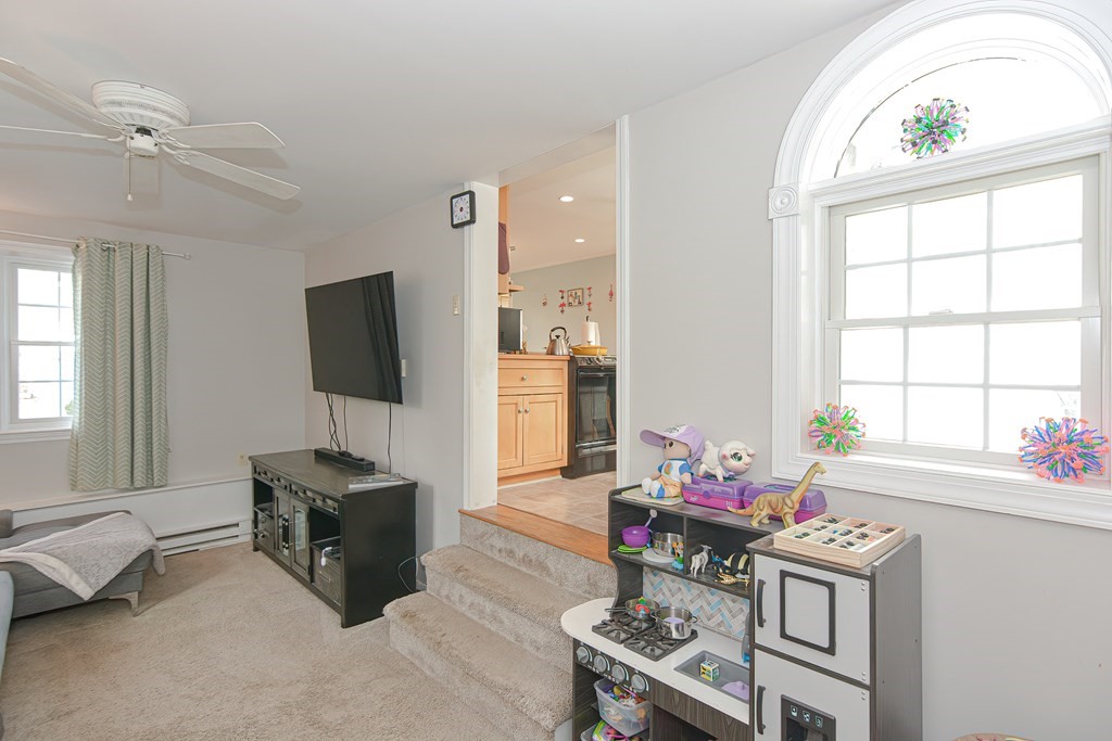 3 Orchard Place Douglas, MA 01516 - Photo 14 of 39 a living room with furniture a flat screen tv and a window