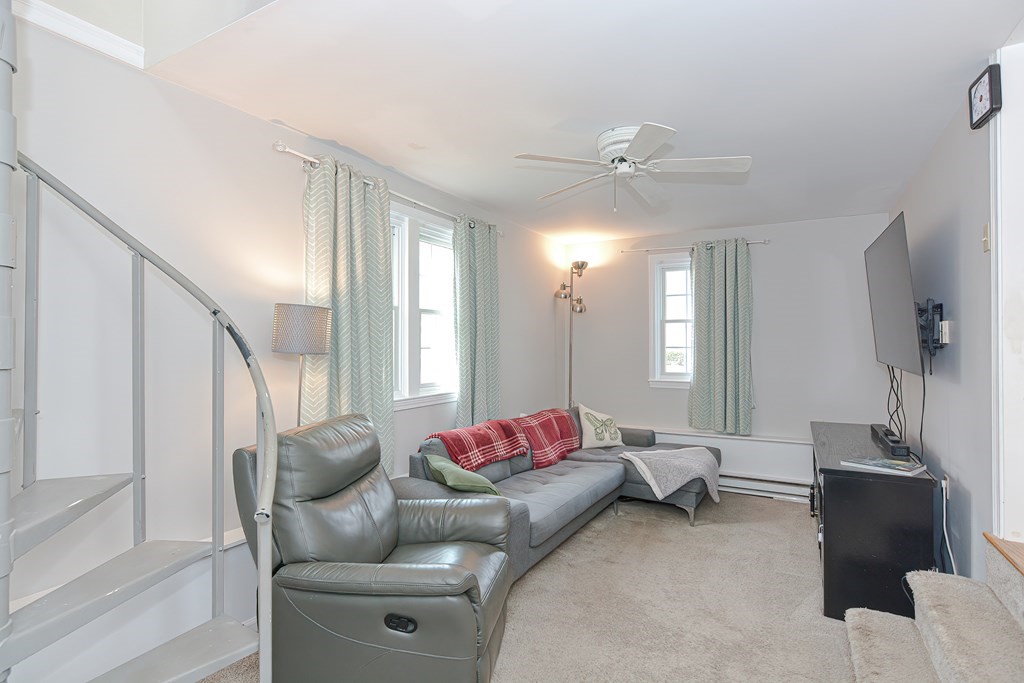 3 Orchard Place Douglas, MA 01516 - Photo 15 of 39 a living room with furniture and a chandelier