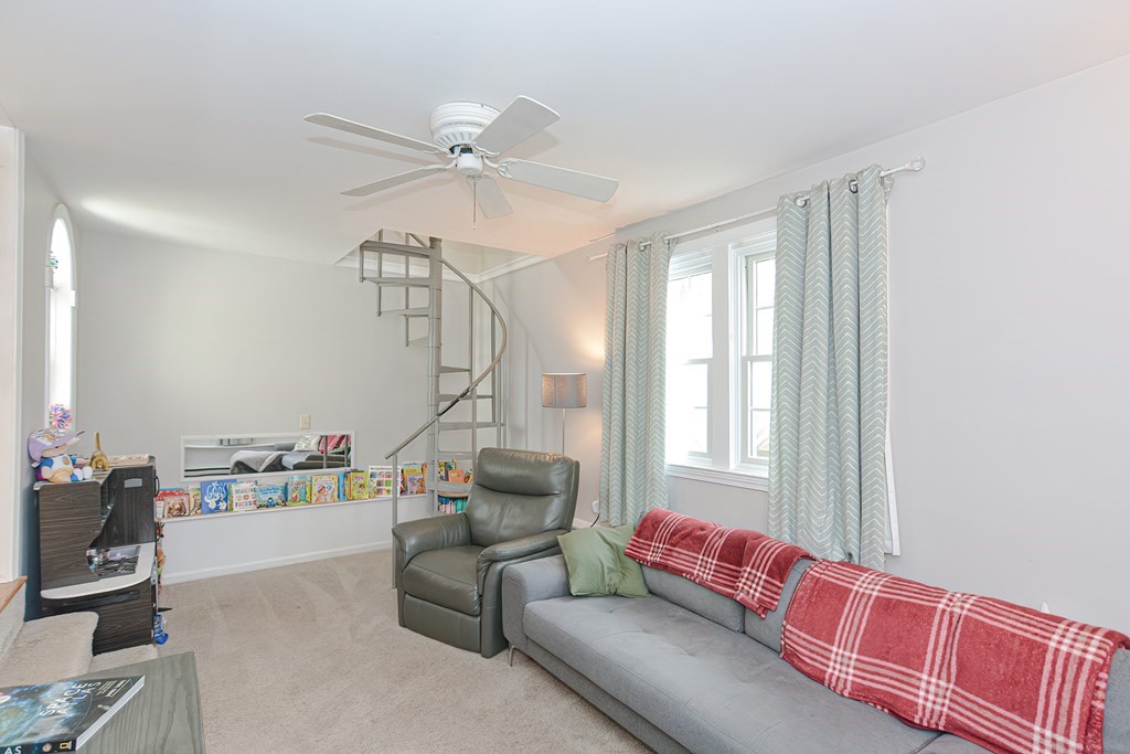 3 Orchard Place Douglas, MA 01516 - Photo 16 of 39 a living room with furniture and a chandelier