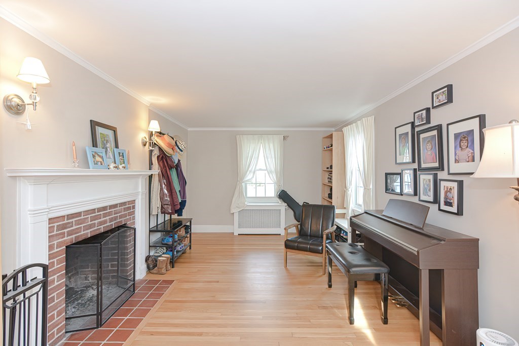 3 Orchard Place Douglas, MA 01516 - Photo 31 of 39 a living room with furniture a fireplace and a flat screen tv
