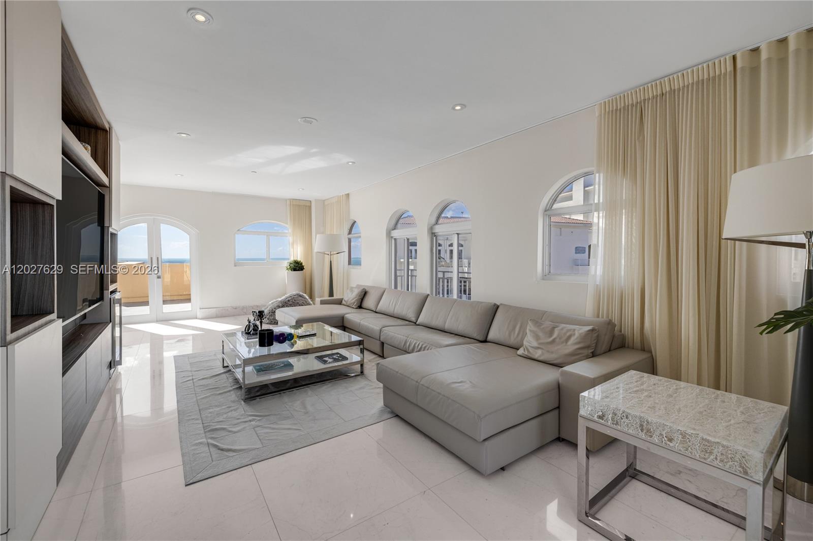 799 Crandon Boulevard, Unit PH8 Key Biscayne, FL 33149 - Photo 20 of 47 a living room with furniture and a large window