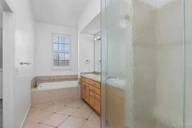 a spacious bathroom with a granite countertop tub sink and mirror