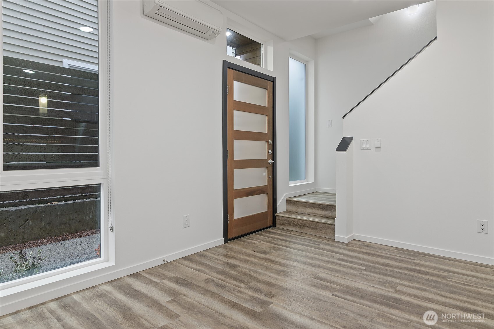 9221 Linden Avenue North, Unit A Seattle, WA 98103 - Photo 11 of 29 a view of empty room with wooden floor and fan