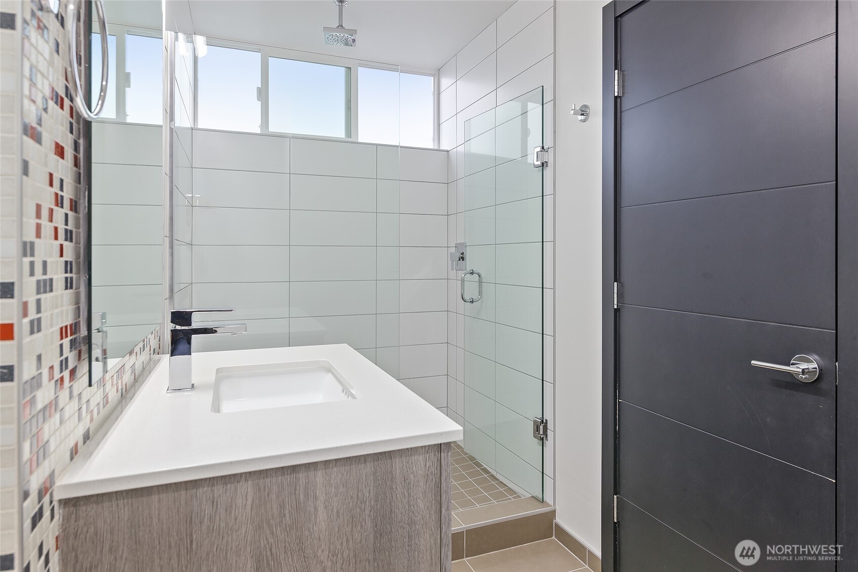 9221 Linden Avenue North, Unit A Seattle, WA 98103 - Photo 15 of 29 a bathroom with a sink a toilet and shower