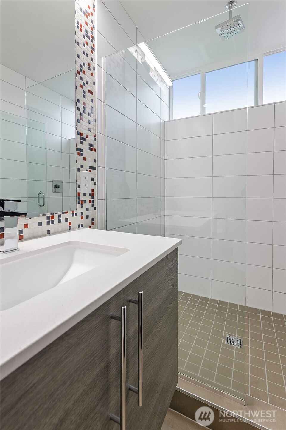 9221 Linden Avenue North, Unit A Seattle, WA 98103 - Photo 16 of 29 a bathroom with a sink a toilet and a mirror