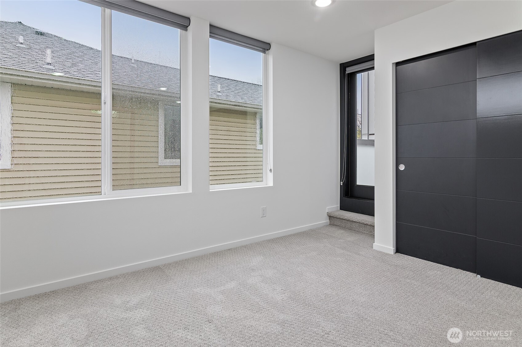 9221 Linden Avenue North, Unit A Seattle, WA 98103 - Photo 17 of 29 an empty room with windows