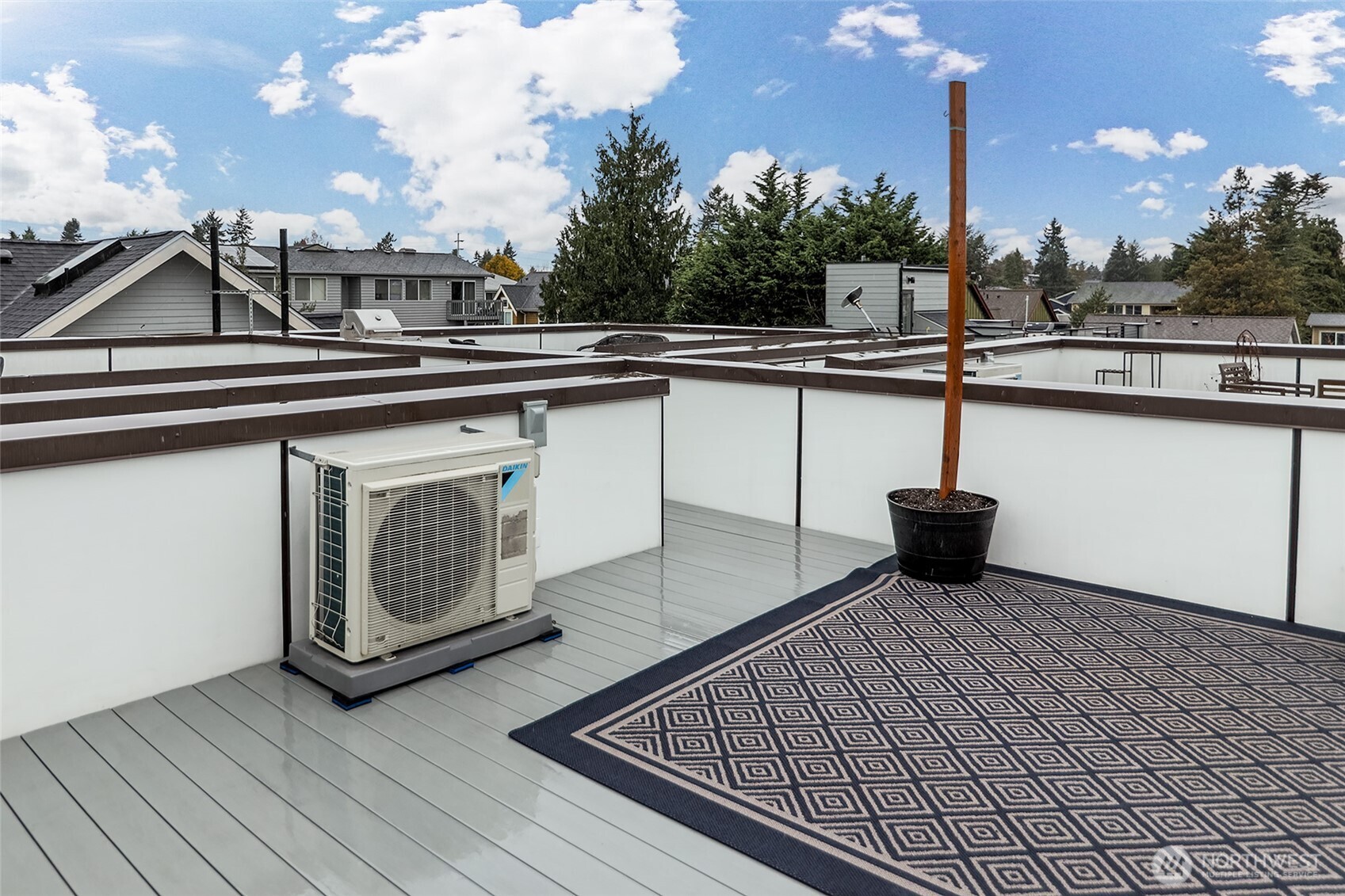 9221 Linden Avenue North, Unit A Seattle, WA 98103 - Photo 24 of 29 a terrace with a bench and trees