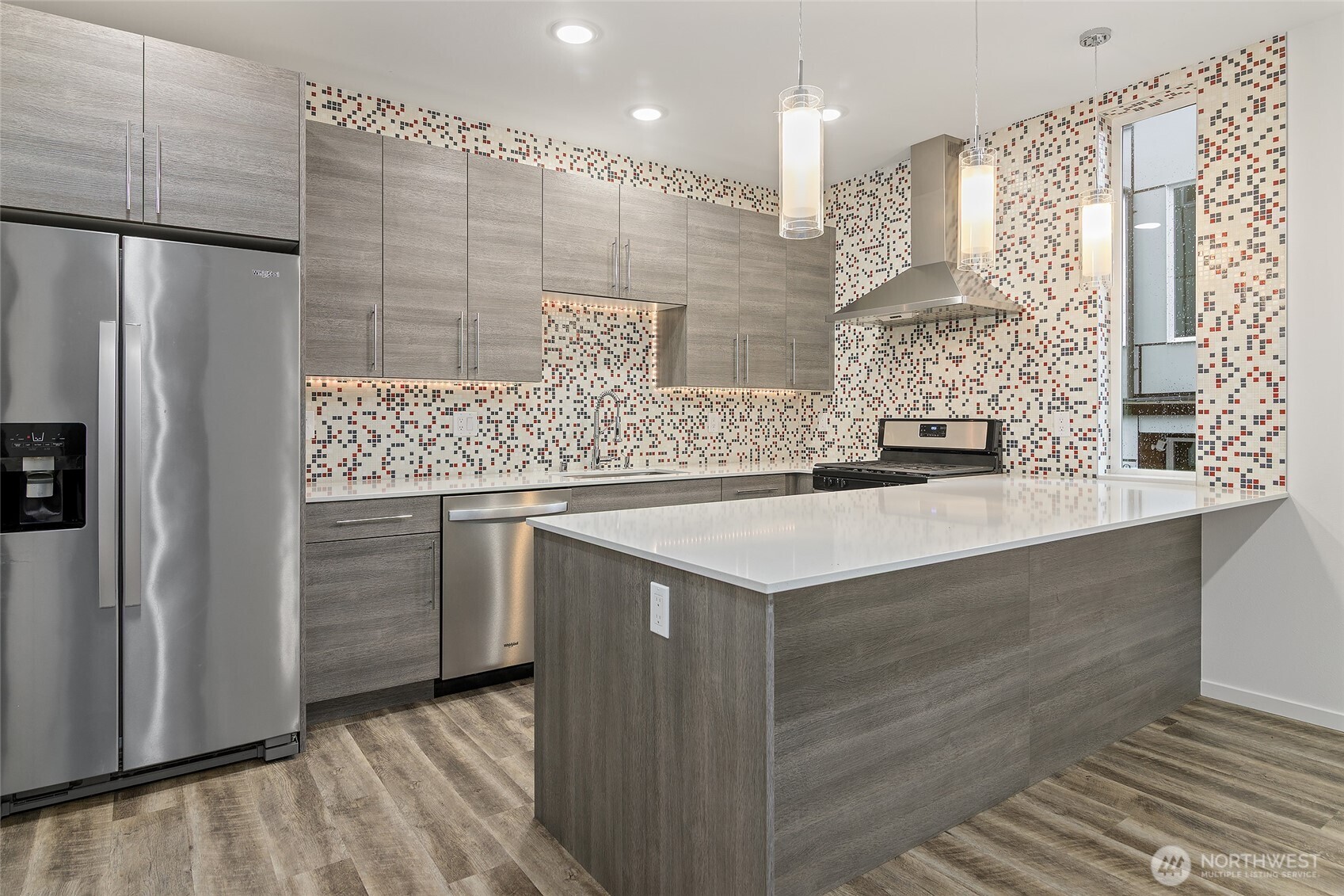 9221 Linden Avenue North, Unit A Seattle, WA 98103 - Photo 5 of 29 a kitchen with a sink dishwasher a refrigerator and cabinets
