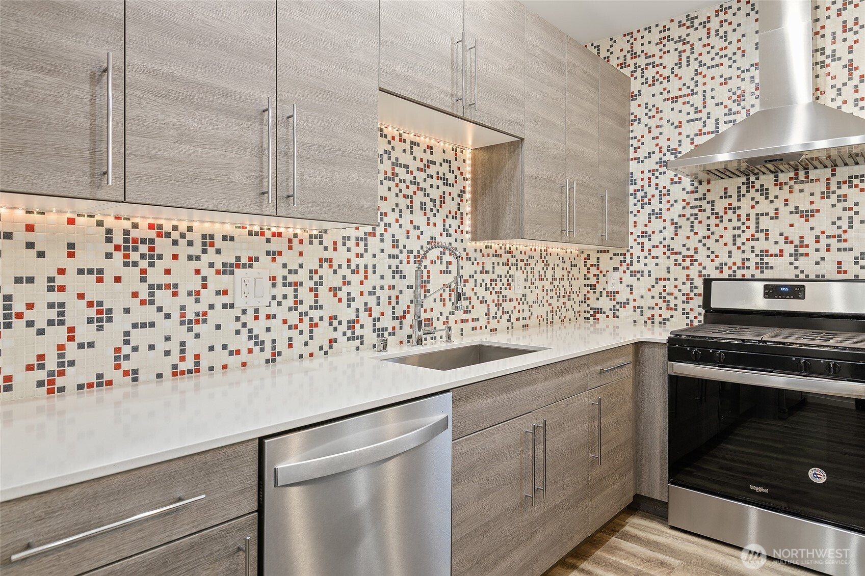 9221 Linden Avenue North, Unit A Seattle, WA 98103 - Photo 6 of 29 a kitchen with granite countertop cabinets and a stove