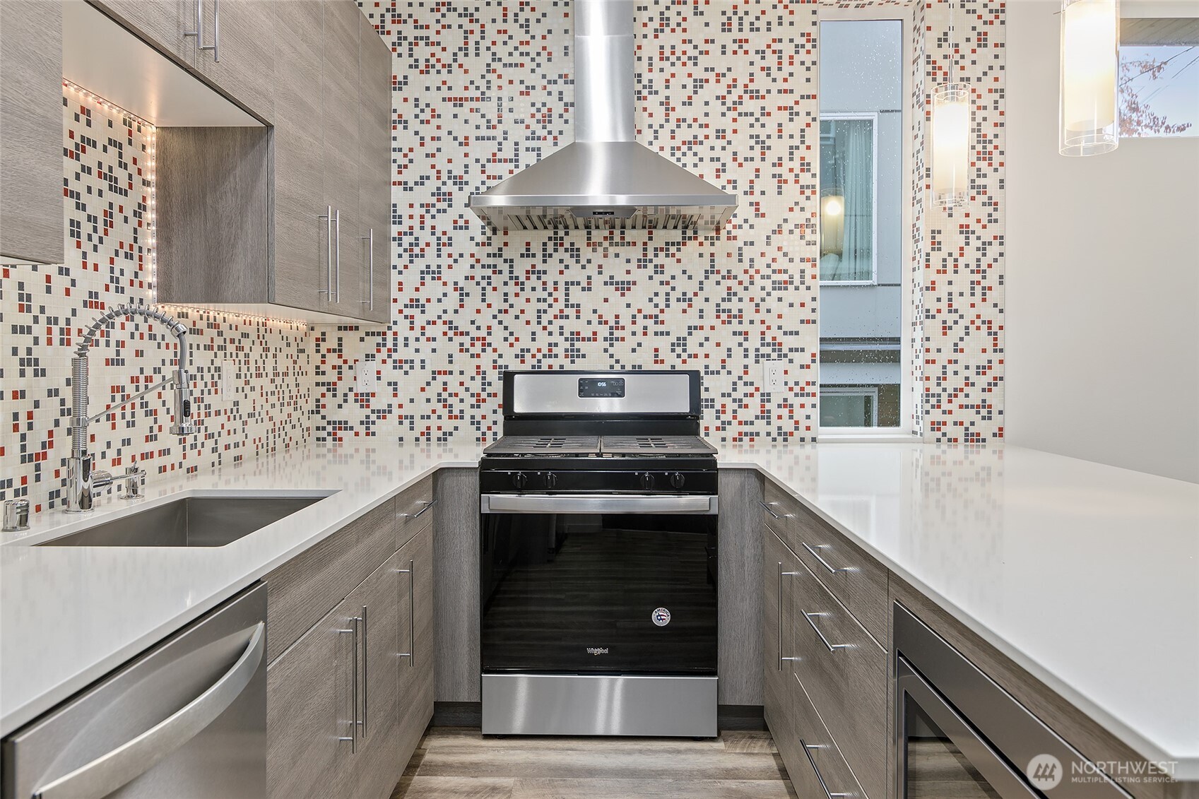 9221 Linden Avenue North, Unit A Seattle, WA 98103 - Photo 8 of 29 a kitchen with granite countertop a sink stove and cabinets
