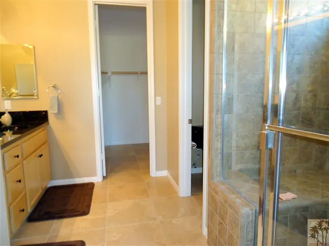 a view of walk in closet and bathroom