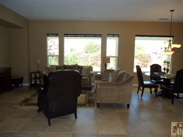 a living room with furniture and large windows