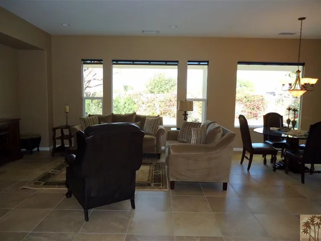 a living room with furniture and large windows