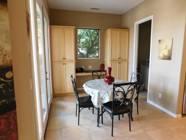 a view of a dining room with furniture and a window
