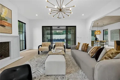 a spacious bedroom with a bed and a chandelier