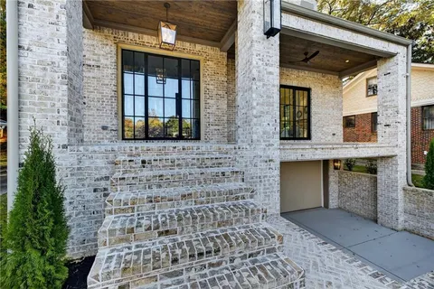 a living room with furniture a large window and a fireplace