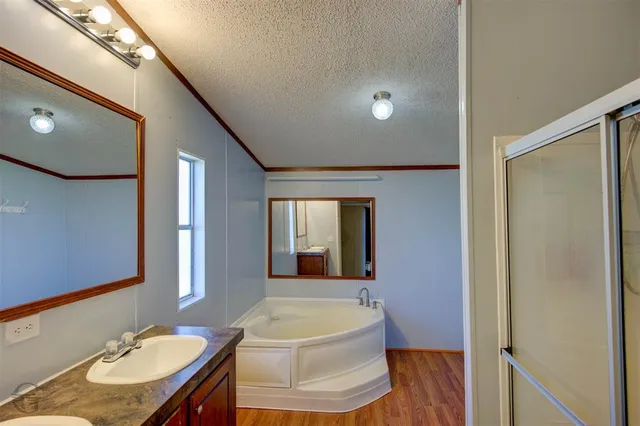 a bathroom with a sink mirror and a shower