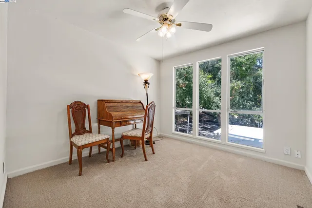a dining room with furniture and a window