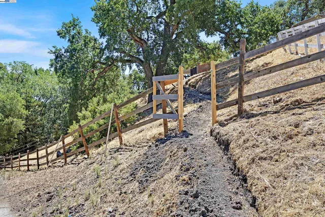a view of an outdoor space with wooden fence