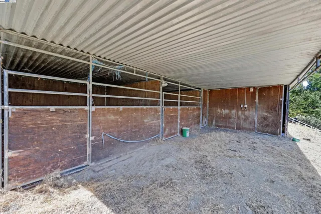 a view of an empty room with wooden walls