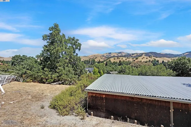 a view of a roof deck with wooden fence and floor
