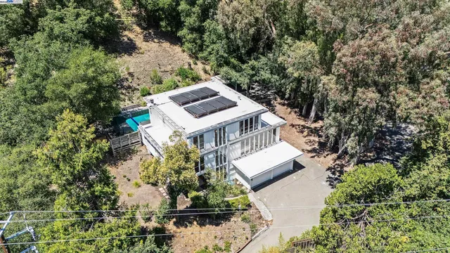 an aerial view of a house with a yard