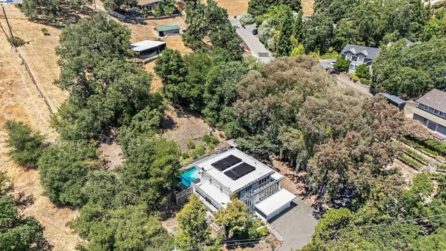 an aerial view of a house with a yard