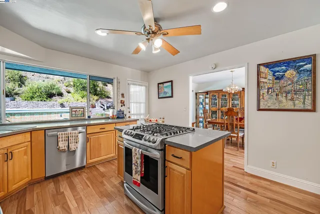 a kitchen with stainless steel appliances granite countertop a stove and a sink