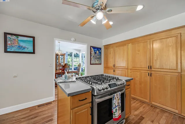 a kitchen that has a stove and a table in it