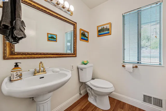a bathroom with a toilet a sink and mirror