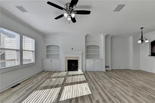 wooden floor in an empty room with a fireplace
