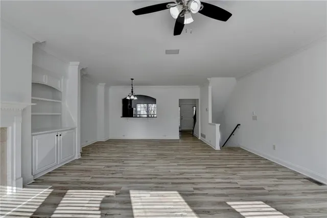 a view of empty room with wooden floor