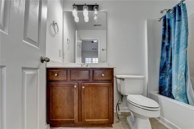 a white toilet sitting next to a bathroom sink