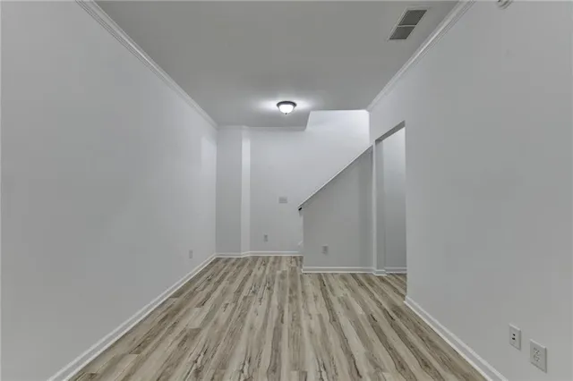 a view of room with stairs and wooden floor