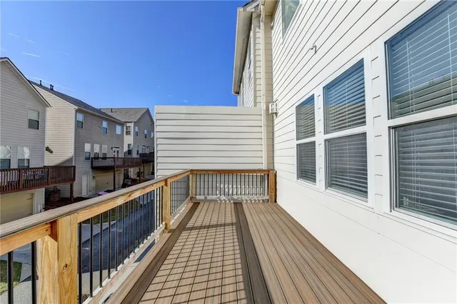 a view of balcony with wooden floor and seating space