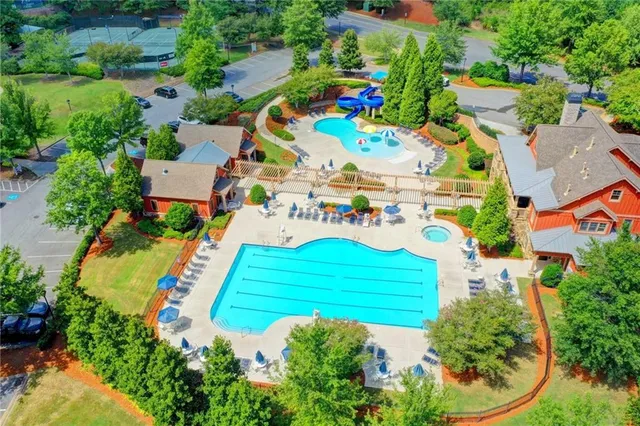 an aerial view of a tennis ground and trees all around