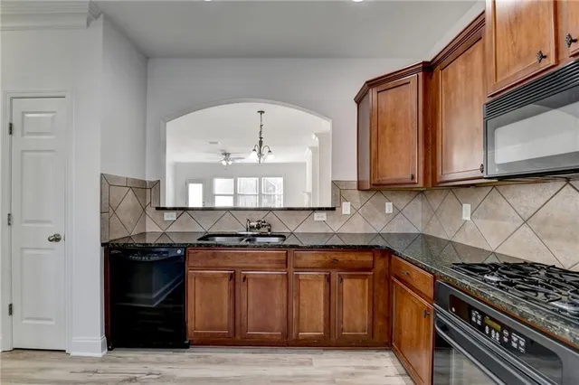 a kitchen with a stove and a sink