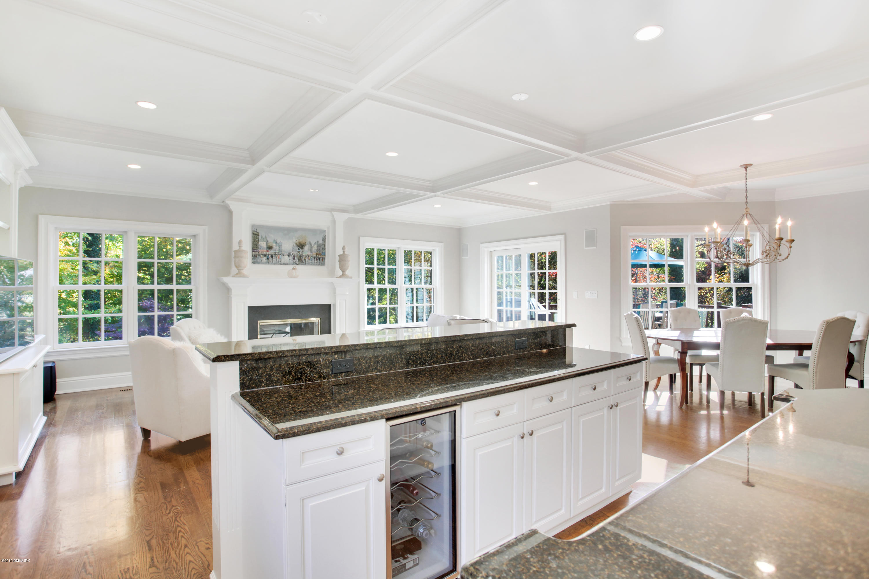 16 Normandy Lane Riverside, CT 06878 - Photo 15 of 43 a kitchen with granite countertop a stove a sink a dining table and chairs with wooden floor
